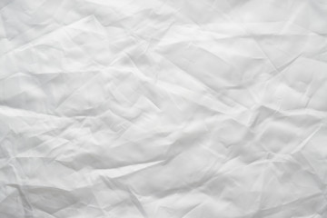 Texture of crumpled white fabric with a blue tint. White flag, reflector. Creative vintage background.