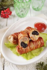 Pork rolls with prunes and cheese in bacon.