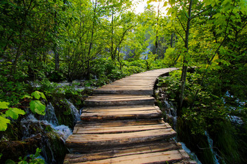 Wooden stairs leading up a big waterfall in the Plitvice Lakes National Park in Croatia