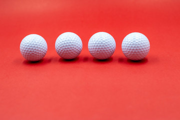 Golf balls are on red background