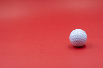 Golf balls are on red background