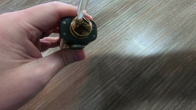  E-cigarette vaping concept shot putting liquid from glass bottle on coils