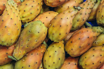 Close up on a heap of India fig opuntia fruits on a indoor food market called Mercato Delle Erbe in Bologna city, Italy
