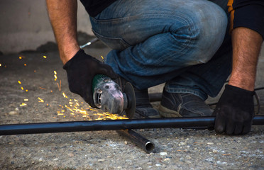 Man cutting a gas pipe for central gas installation