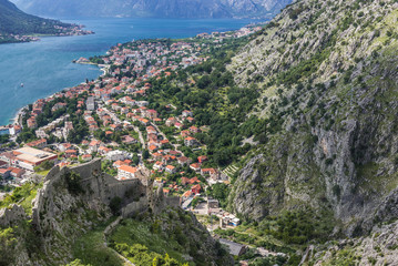 Fototapeta na wymiar Aerial view from walls of St John Fortress in Kotor with Dobrota town on background, Montenegro