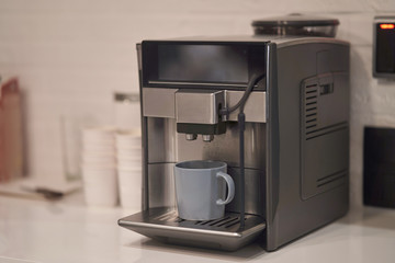 Coffee machine with a cup. Making coffee