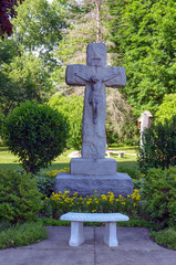Stone statue of the crucifixion in a park