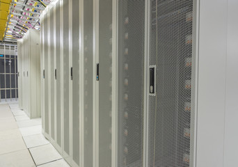 Data center neatly arranged white network cabinets