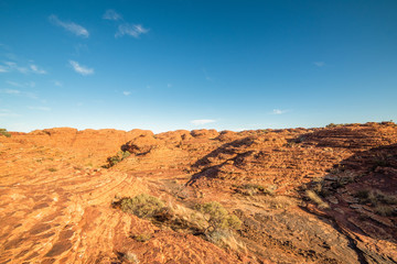 Fototapeta na wymiar Lookout over the canyon of red arid earth in the bright sun