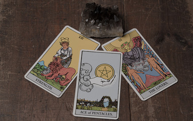 Tarot cards on wooden table with crystals