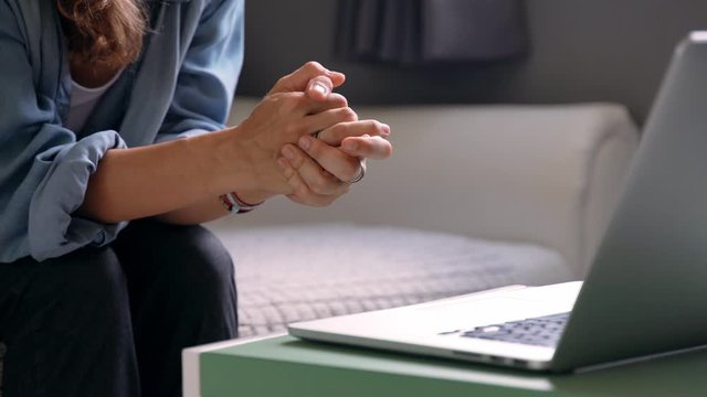 Close Up shot of woman's hand gesturing in front of the laptop. Online consultant at the work.