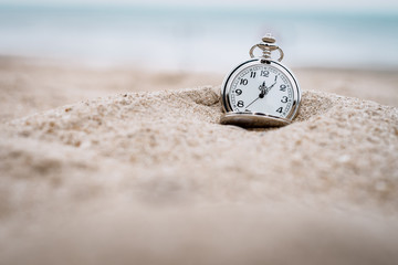 Retro pocket watch on the beach