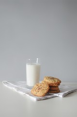 Stack of handmade oatmeal cookies with glass of milk