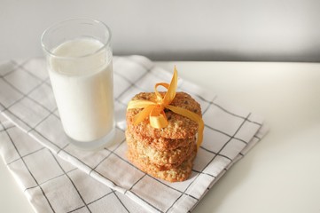 Stack of handmade oatmeal cookies with glass of milk