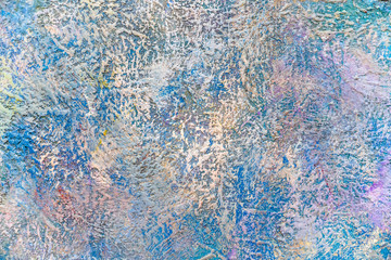 The texture of the multi-colored gamut of paint several times applied to the wall