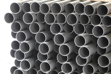 gray PVC tubes plastic pipes stacked in rows pattern