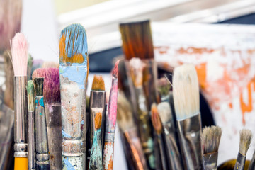 Fototapeta premium Working set of brushes in the artist workshop await the creation of the next masterpiece