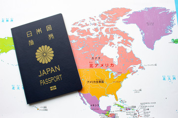 Japanese passport front cover on a map on North America on the background