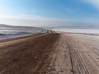 winter country road in the snow covered steppe and clear blue sk