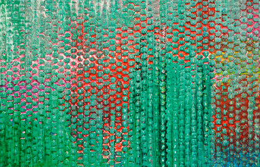Green pimples on a red background. A daub in green on a canvas. Abstract background.