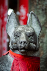 Ancient Japanese kitsune statue guardian, fox guard statue old shinto shrine in Tokyo, Inari Shrine