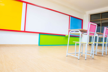 Desks, chairs and white board in the kindergarten classroom.