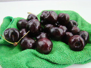 Bunch of fresh cherries on green cloth