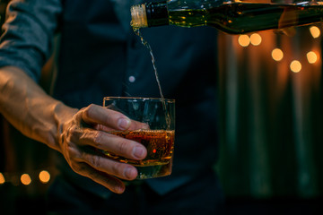 Whisky is poured into glass Beautiful bokeh