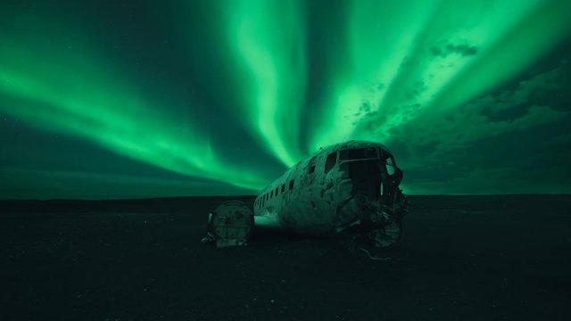 Cinemagraph of aurora borealis in the sky over airplane wreck