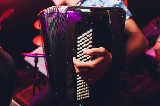 The musician plays the accordion close-up microphone.
