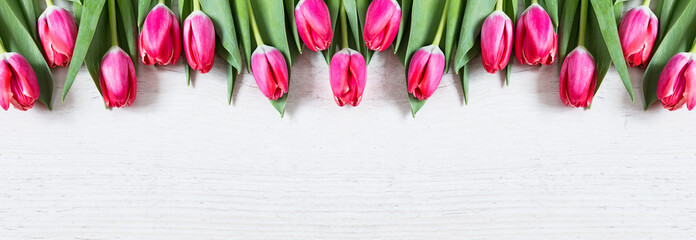 Beautiful pink tulips on wooden background