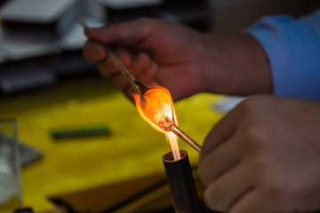 Artist works on glass with fire close-up view in Guiling, Guangxi province, China