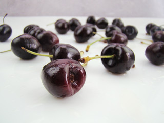Freshly dripped cherries on a white background