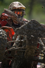 Mud flies as an ATV rider works through a course.