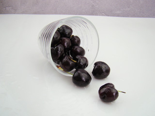 The cherries inside the glass are scattered and poured out