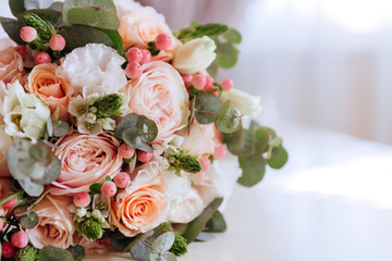 Wedding flowers, bridal bouquet closeup. Decoration made of roses, peonies and decorative plants