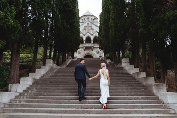 Happy bride and groom near old castle in wedding day