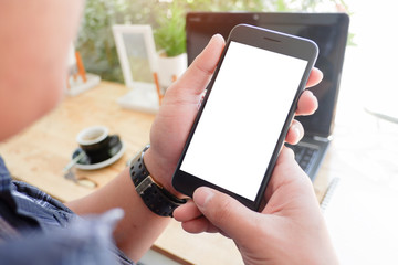Mockup picture of business woman’s hands or man's hands holding smart phone with white blank screen in modern place.