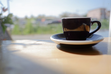 The background of view white office desk table with the a black cup of coffee on the modern space, flat lay.