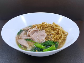 Top view of fried noodle with pork and chinese kale on wooden table as a background, This food is most popular and simple food (Rad Na), Ready to eat