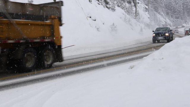 Snow Plow On Highway During Winter Storm