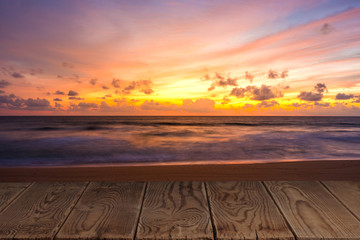 Fototapeta na wymiar Empty wooden table with view of beautiful beach in the twilight period.