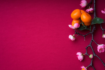 Chinese New Year decorations with red background with assorted festival decorations. Chinese characters means abundant of wealth, prosperity and luck. Flat lay.