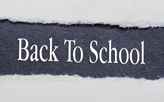 Back To School words under torn black paper.