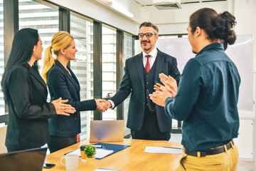 Shake hands Business people teamwork group are happy finished success business project standing in office congratulation
