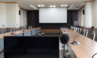 Close up microphone on brown table in meeting room