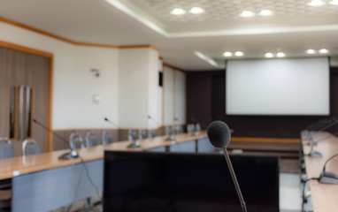 Close up microphone on brown table in meeting room
