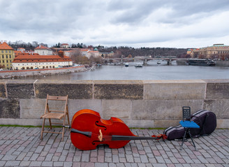 double bass and chairs for street musicians on the Charles bridge in Prague