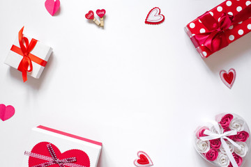 Background with copy space with romantic decor for Valentine's Day: gift boxes with bows and hearts