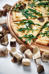 Pizza with Boletus edulis (king bolete) on white background